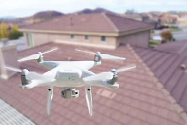 Close up view of a drone flying over a rooftop