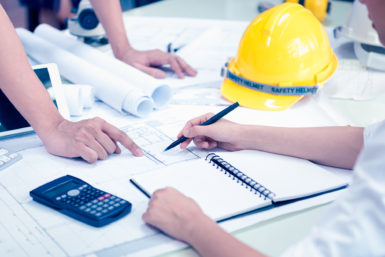 People looking over blueprints